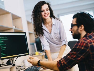 Programmers cooperating at information technology company