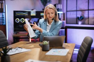 Business woman using headset and laptop for video call