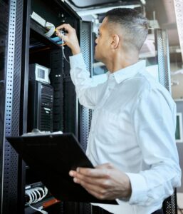 Information technology, server and man engineer with clipboard working, fixing and checking motherb