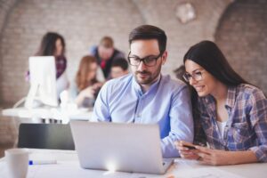 Programmers cooperating at information technology company