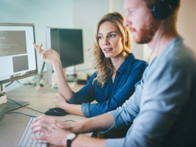 Programmers cooperating at information technology company